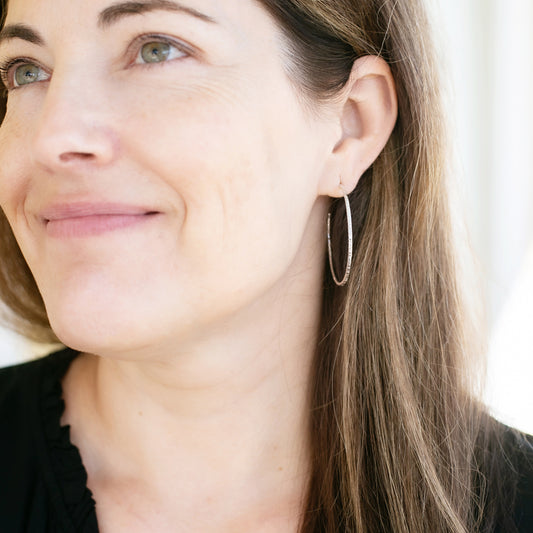 Sparkly textured hoop post earrings on model
