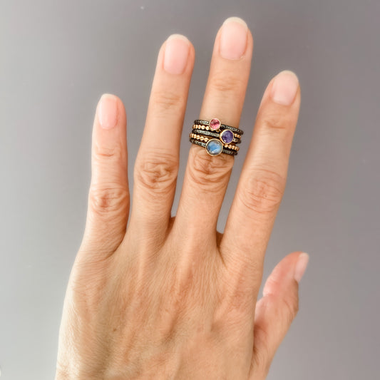Gold and Oxidized gemstone stacking rings with Tourmaline, moonstone, and tazanite